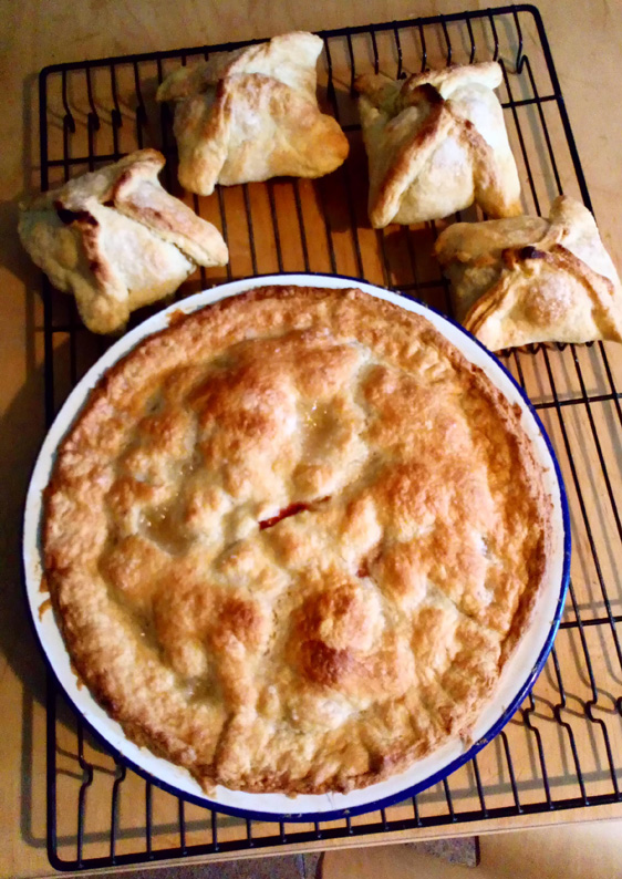 Apple pie and dumplings on a wire tray.